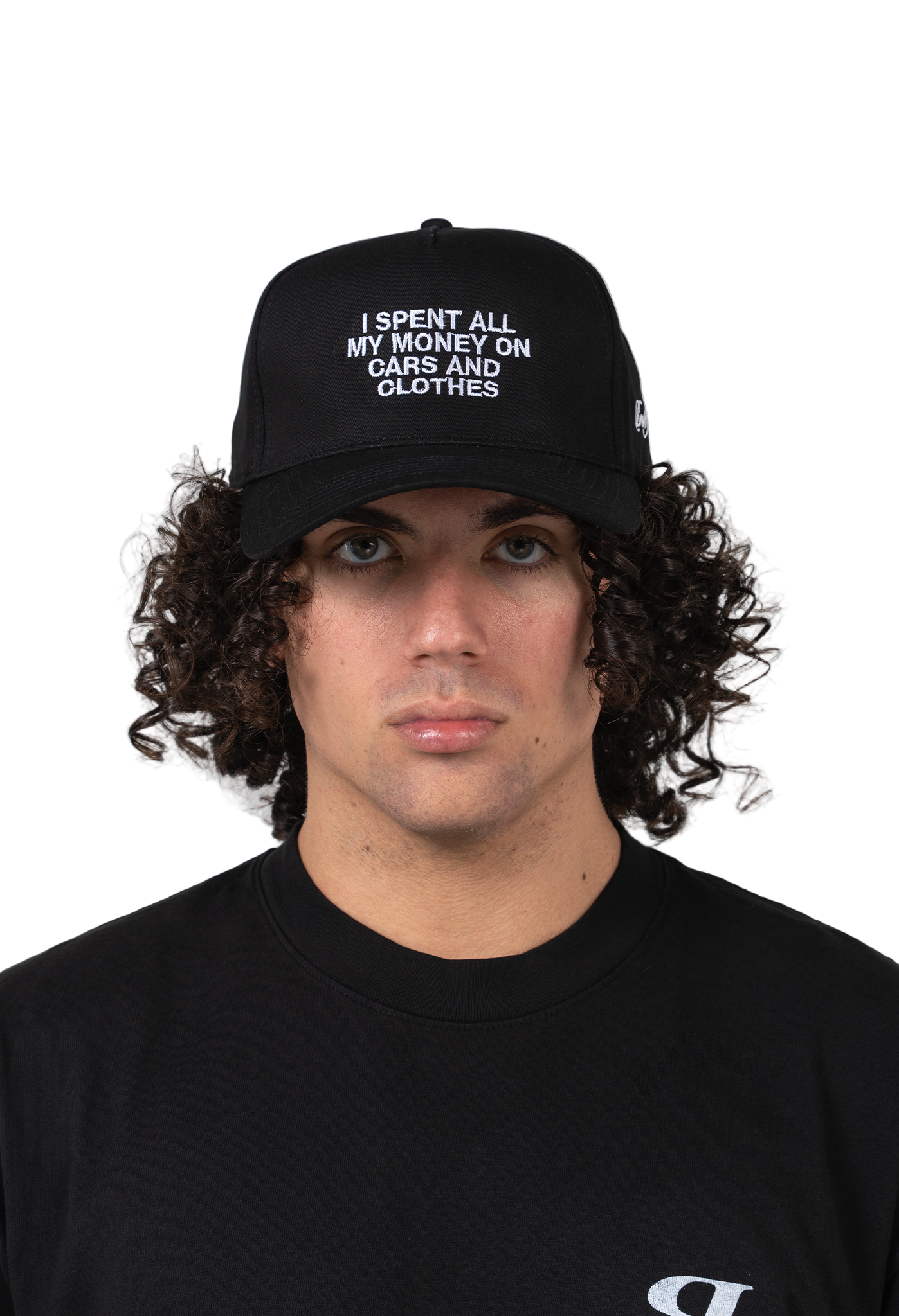 Person wearing a black cap with text and a black shirt on a white background