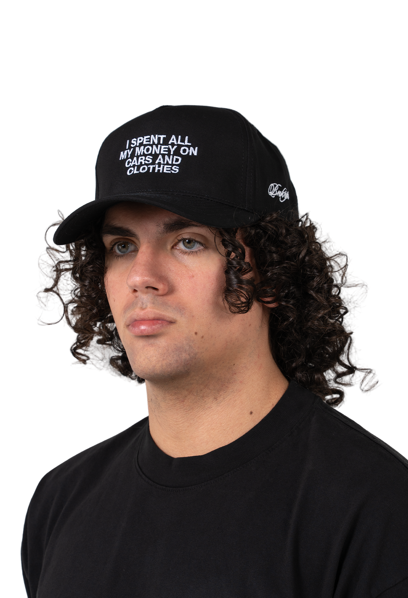 Person wearing a black cap with text saying I spent on my money on cars and clothes on a white background